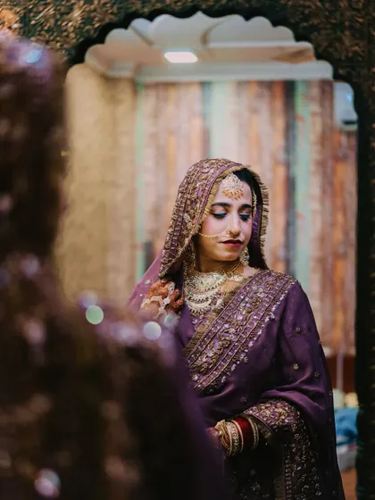 A quiet moment of reflection for the bride. This mirror shot adds depth and a story-like quality to the bridal portrait.