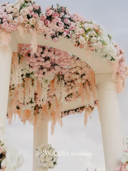 A close-up of the floral arch from the Dubai wedding, showing the intricate arrangement of cascading pastel flowers.