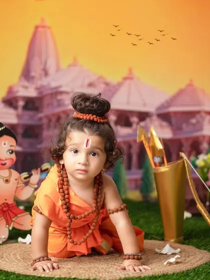 Jai Shri Ram! A little one dressed as Lord Rama crawls towards his bow and arrow, with Hanuman cheering him on.