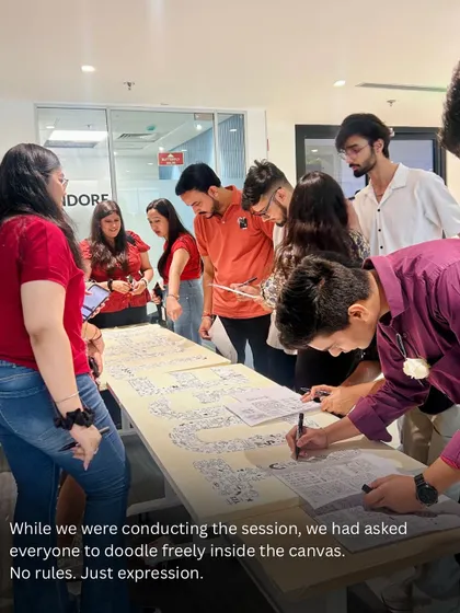 The instruction was simple: doodle freely. No rules, just expression. This photo shows the Protiviti team getting started on their massive canvas.