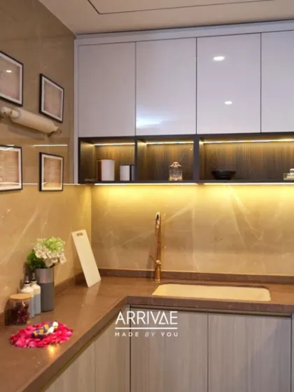 This kitchen showcases how to create a luxe look with a neutral palette. The warm lighting under the cabinets highlights the beautiful backsplash and countertop.