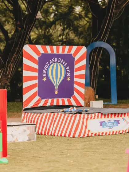 A carnival-themed game booth set up on the lawn. I can organize a variety of classic carnival games to entertain guests of all ages.