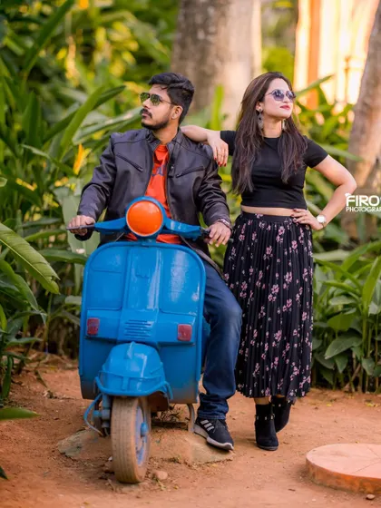 A cool, stylish pose with a vintage scooter. The couple's modern casual wear and sunglasses create a fun, edgy look for their pre-wedding photos.
