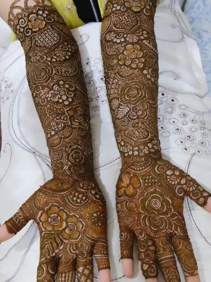 The fresh henna paste shows the detail and precision of the work. This full bridal design is ready to develop into a beautiful dark stain.