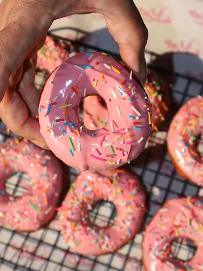 A close-up of our classic pink-glazed donut with colorful sprinkles. It’s a simple treat that always brings a smile.
