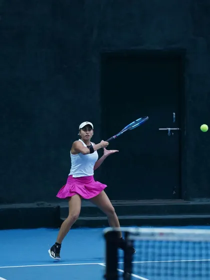 A powerful forehand shot captured mid-swing, highlighting the kinetic chain and technique we refine in our players.