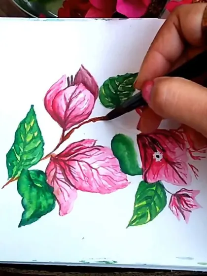 A work-in-progress shot showing the outlining process on the Bougainvillea watercolor. Adding fine black lines helps define the shapes of the leaves and flowers, giving the piece a clean, illustrative finish.