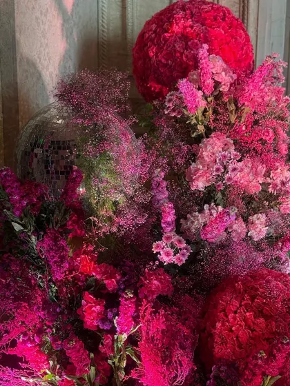 A symphony of pink petals. This close-up shows the rich textures of the Mehendi decor, where I layered different flowers like hydrangeas and baby's breath, and even added a disco ball for a touch of playful glamour.