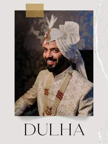 A smiling portrait of the groom in his wedding sherwani, looking dapper and ready for his big day.