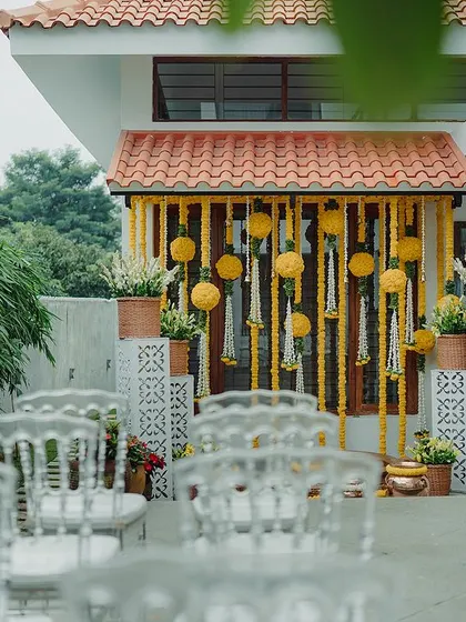 A duplicate image of the beautiful Haldi decor with acrylic chairs.