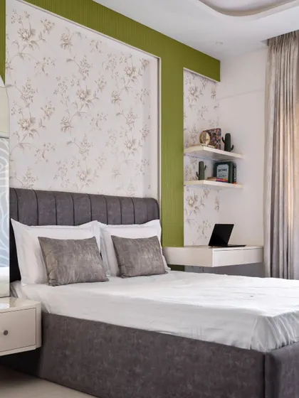 The daughter's room in 'Muditā', where the headboard panel extends to frame a dressing unit on one side and a workspace on the other.