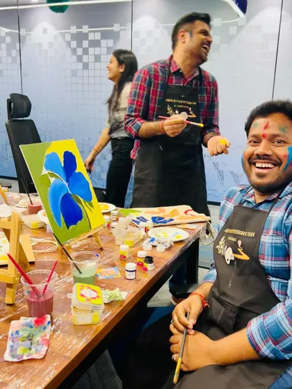 A participant beaming with happiness, his face smeared with color. This is what a creative celebration looks like.