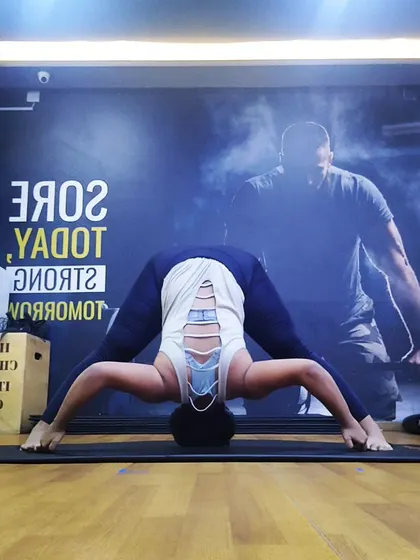 Prasarita Padottanasana, the wide-legged forward bend. This pose is excellent for stretching the hamstrings and inner thighs while releasing tension in the lower back.