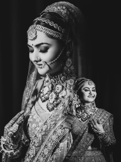 A creative double-exposure in black and white, blending two beautiful bridal portraits into one artistic image. This technique adds depth and a timeless quality to the shot.