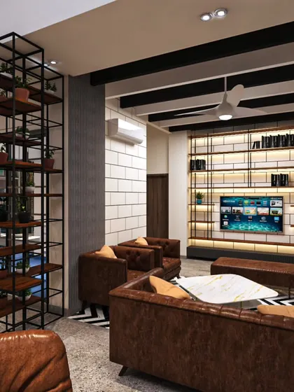 An industrial-chic lounge area designed for a modern office. We used a mix of exposed brick-style walls, metal shelving, and comfortable leather furniture to create a relaxed yet professional atmosphere, perfect for team brainstorming or client meetings.