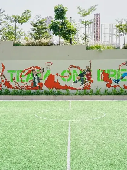 The full view of our dynamic basketball court mural for DNR Builders. The artwork spans the length of the court, creating an energetic backdrop for the game.