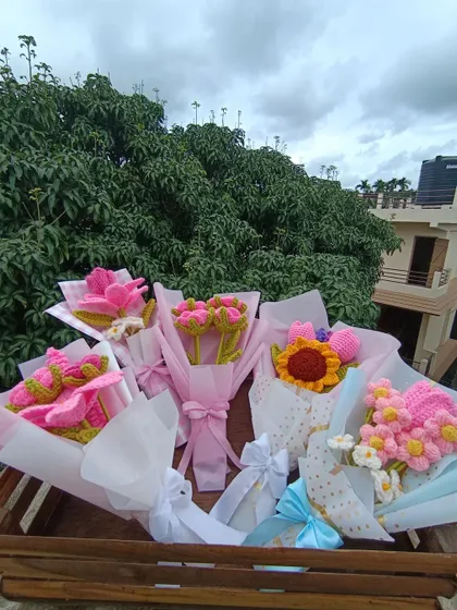 A collection of five different custom-wrapped pink bouquets, each with a unique combination of flowers.