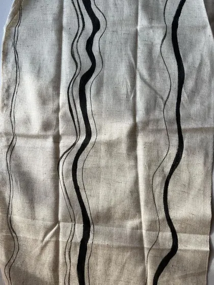 This is one of my favorite prints from the season, featuring hand-painted wavy lines on natural cotton. The organic, flowing design is created with a natural black pigment, perfect for modern and minimalist collections.