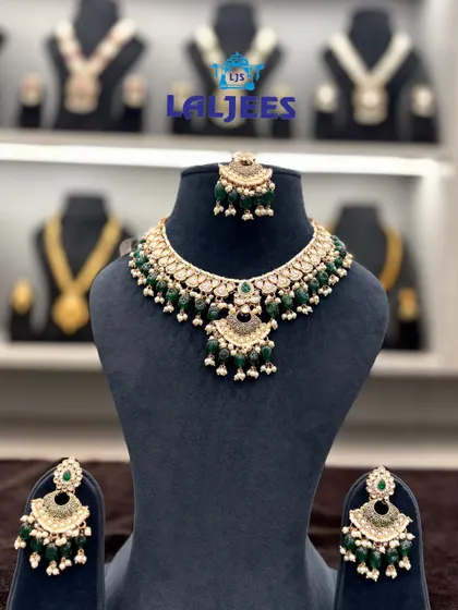 An elegant green beaded choker set with matching jhumkas, perfect for adding a pop of color to your bridal look.
