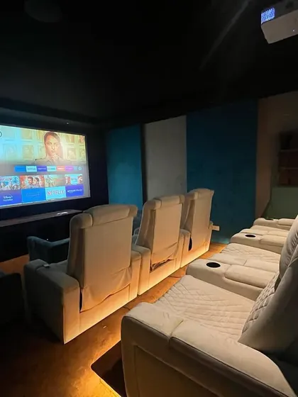 A view from the side, showing the comfortable recliners and the large screen, perfect for an immersive movie night.