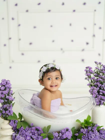 A serene moment in a tub full of lavender. This baby girl looks so peaceful and happy surrounded by the beautiful purple blossoms.