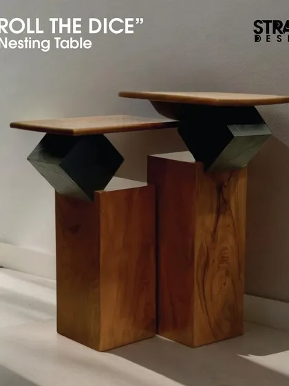 The 'Roll The Dice' nesting tables are an edgy blend of modern design and natural elements. They feature solid teak wood bases with a natural finish and a stone veneer cube that balances the tabletop.