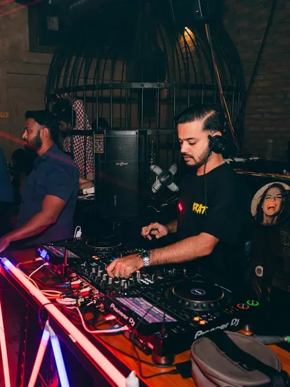 A side profile shot of me at the decks, with the club's unique decor in the background.