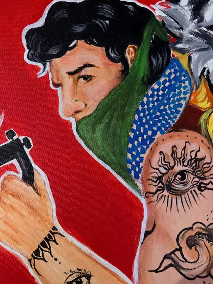 A close-up on another part of the pop-art canvas, this time showing a man with intricate tattoo illustrations on his arm.