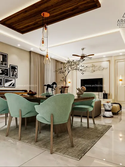 A bright and airy dining space featuring mint green chairs that add a pop of color. The wooden ceiling panel and gallery wall bring warmth and personality to the room.
