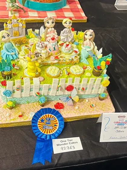 I poured my heart into this piece for the national Cakeology competition and was so proud to bring home the silver award. It’s a whimsical tea party with some of my favorite characters, and every tiny detail is sculpted from sugar.