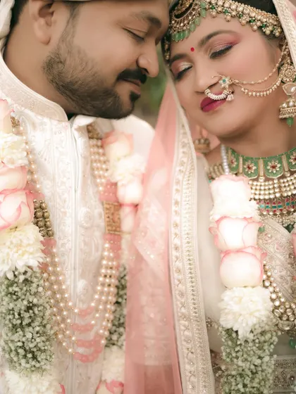 A close-up, intimate portrait of the couple, their eyes closed in a moment of serene connection.