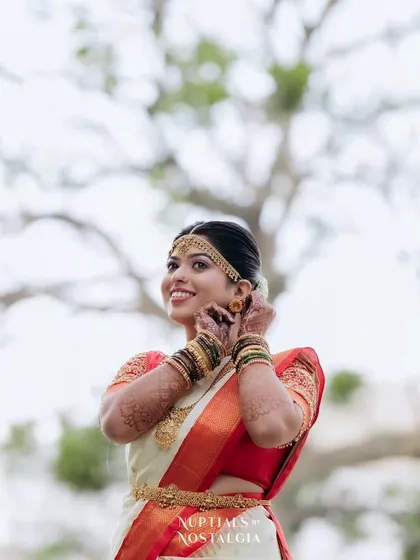 Rachana looking joyful on her wedding day. This candid shot captures the essence of a happy bride, with makeup that looks fresh and natural.