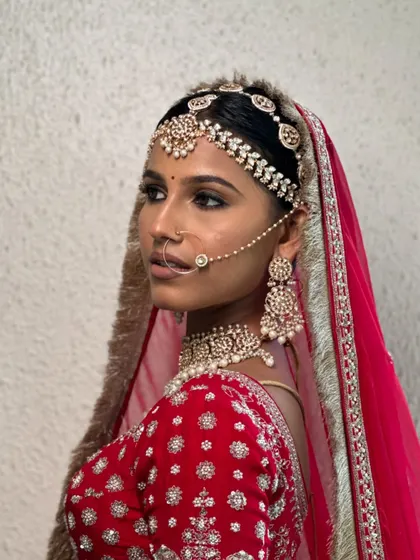 A side profile that highlights the intricate matha patti and nath.