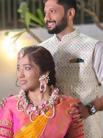 A lovely couple portrait from a pre-wedding ceremony. The bride is wearing our custom pink floral jewellery set, which adds a soft, romantic touch.