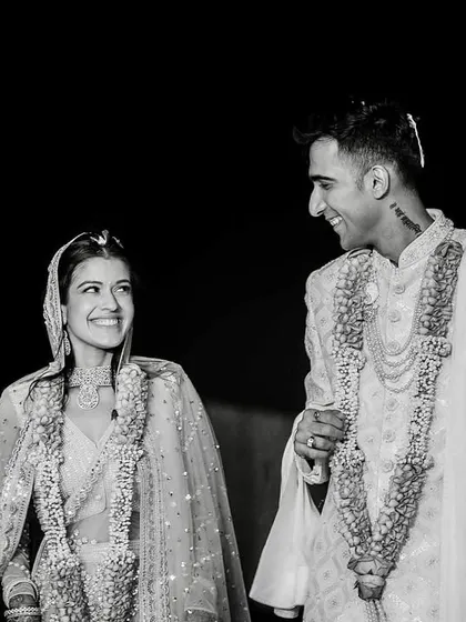 A classic black and white portrait of the couple after the Varmala ceremony. Their smiles and the way they look at each other speak volumes.