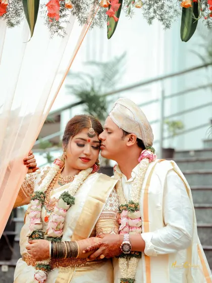A tender embrace between the bride and groom, framed by the beautiful architecture of their wedding venue.