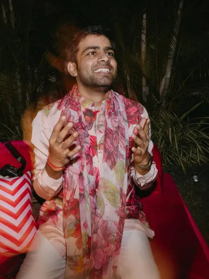 A candid shot of the groom enjoying his sundowner mehendi. I styled him in this fun and floral jacket kurta set with a long scarf, a perfect choice for a vibrant and electric daytime event.