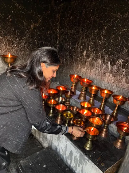 Lighting butter lamps in a monastery, a simple act of prayer and offering. My retreats are designed to weave these moments of spiritual connection into our daily practice.