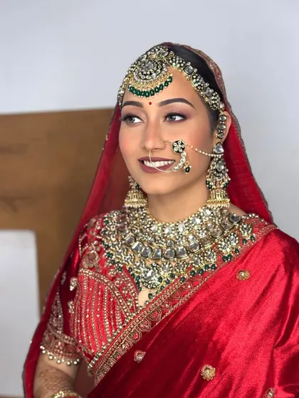 Another angle of our royal bride. Her smile and radiant skin are the highlights of this look, complemented by heavy traditional jewelry.