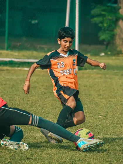 A slide tackle comes in to stop an attack, a moment of high drama in the game.