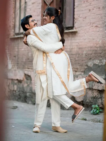 A joyful lift in the middle of the street. These spontaneous moments of happiness are what make a pre-wedding shoot so memorable.