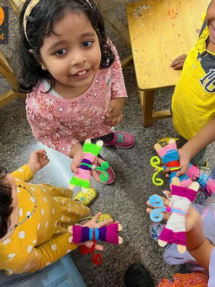 A group of our youngest artists with their yarn-wrapped creations. It's so wonderful to see them all holding up their unique and colorful butterflies.
