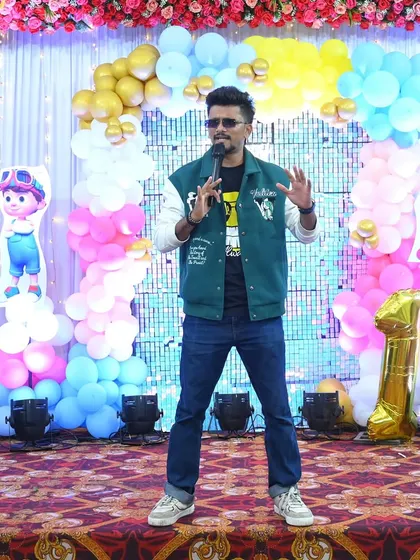 Another shot of me hosting a first birthday party, engaging with the little ones and their parents.