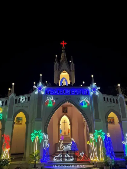 The "Peace on Earth" message shining brightly in neon lights above the entrance of Mount Mary Church, decorated for the festive season.