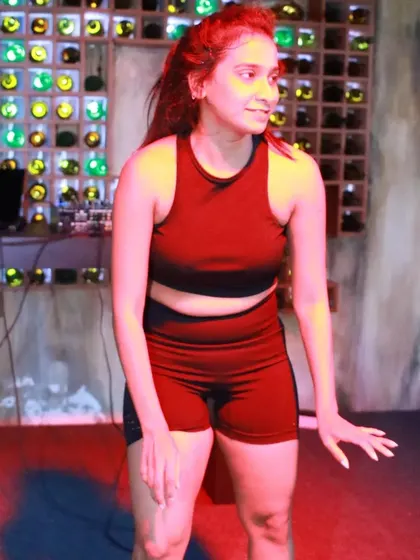 A poised moment before diving into the next sequence of the routine. This shows the control and technique that is part of the high-energy choreography.