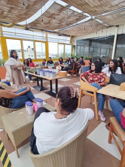 Participants listening intently during a terrarium workshop on a beautiful rooftop. I love hosting sessions in bright, airy spaces that add to the calming experience.