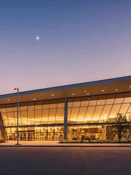 The Goa commercial complex at dusk. The extensive use of glass creates a transparent and inviting structure, while the dramatic roofline makes it an architectural landmark.