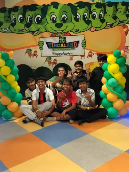 A group of happy kids gathers for a photo in front of our Tingaland backdrop, framed by festive balloons. It's the perfect spot to capture a memory of the party crew.