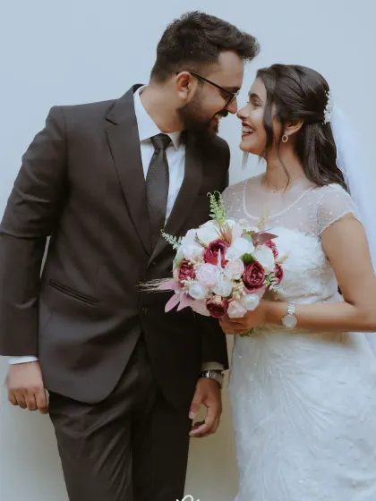 A classic Christian wedding portrait of a couple sharing a happy, loving look after their ceremony.