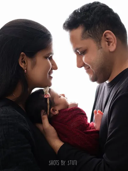 A beautiful backlit portrait of a new family. The soft light creates a halo effect, adding a dreamy, angelic quality to this intimate moment.